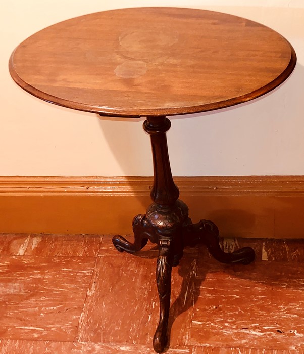 A 19th Century oak wine table, oval top above a baluster column raised on a three carved cabriole