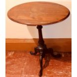 A 19th Century oak wine table, oval top above a baluster column raised on a three carved cabriole