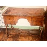 A Queen Anne revival walnut and oak kneehole desk, slight oversailing top with leather writing