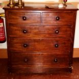 A Victorian mahogany chest of drawers, circa 1880, slight oversailing top, above two short and three