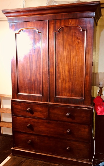 A Victorian mahogany linen press, circa 1860, moulded cornice above two moulded arch panel doors,