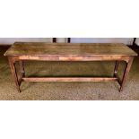 An early 20th Century oak farmhouse kitchen table, three planked top above three single frieze