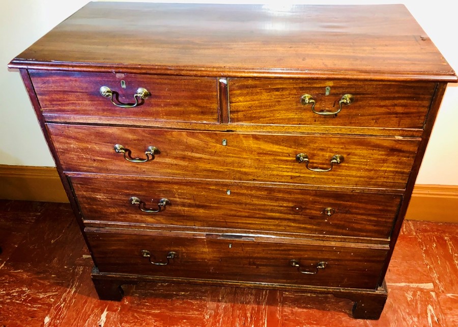 A George III mahogany chest of drawers, circa 1780, slight oversailing moulded edge top, above two