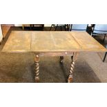 An early 20th Century oak folding leaf table, raised on twisted supports. 75cm H x 89cm D x 76cm