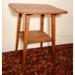 An Arts and Crafts oak hall table, octagonal form top, raised on tapered supports united with a