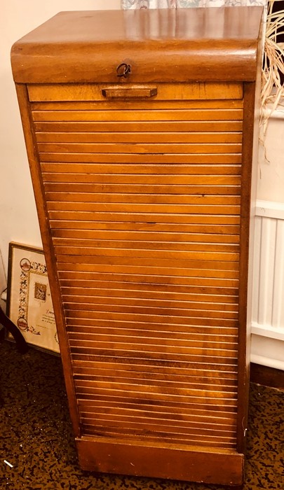 A 1920's oak tambour filing cabinet. 116cm H x 44cm W x 36cm D Condition report: Good overall