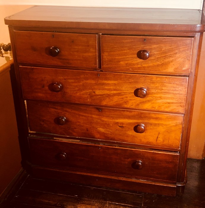 A Victorian mahogany chest of drawers, circa 1870, slight oversailing smooth edge top above two