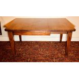 An early 20th century oak extendable dining table, moulded edge top, wind up extending movement,