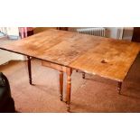 A mid 19th Century oak dropleaf table, circa 1850, rectangular form raised on turned supports.