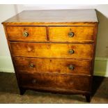 An early Victorian oak chest of drawers, circa 1850, moulded edge top above two short and three long