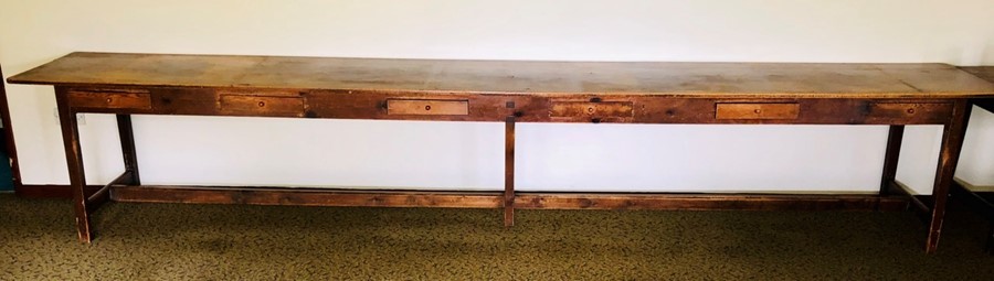 A 19th Century grain pine farmhouse long table, rectangular top, above six drawers to the frieze,