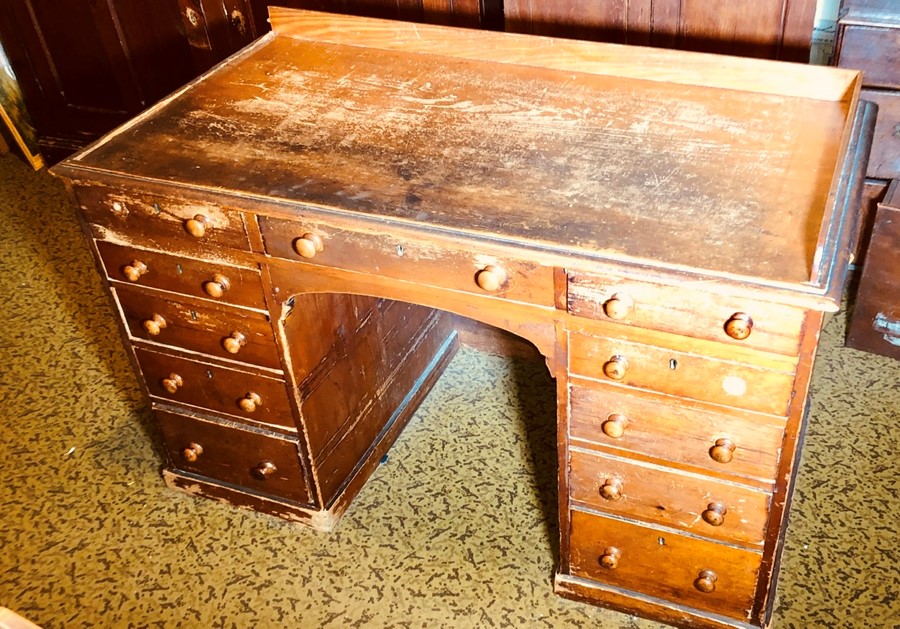 A Victorian oak grained kneehole desk, circa 1880, three quarter gallery and moulded edge top,