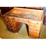 A Victorian oak grained kneehole desk, circa 1880, three quarter gallery and moulded edge top,
