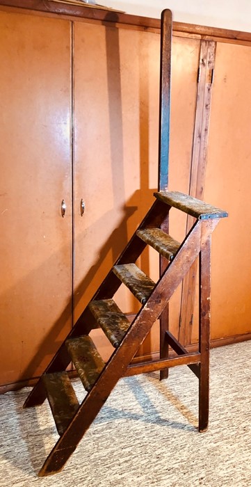 An Edwardian grained pine library steps, carpet fitted on the steps with support handle. 121cm H (