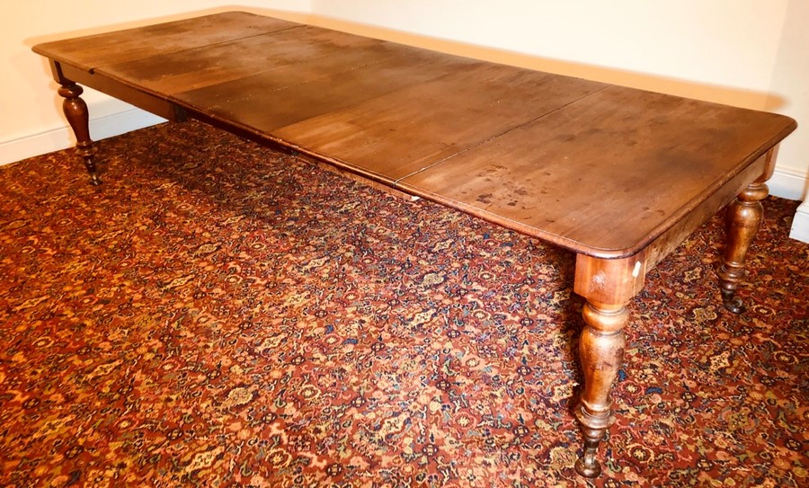 A Victorian mahogany extending dining table, circa 1860, rectangular moulded smooth edge top with