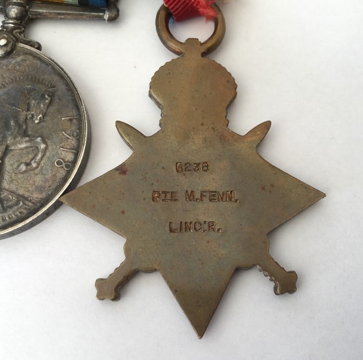 WW1 British 1914-15 Star, War Medal and Victory Medal to Pte M Fenn, Lincolnshire Regt. Mounted on a - Image 2 of 3