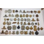 A collection of restrike WW1/WW2 British Army cap badges. Approx 60 in total to include  RA, RAF,