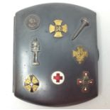 WW1 Austro - Hungarian blued steel cigarette case with eight applied enamel and gilt badges.