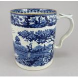An early nineteenth century blue and white transfer-printed tankard, c.1815-25. It is decorated with