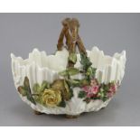 A late nineteenth century English porcelain basket, c. 1860-80. It has simulated branch handle and