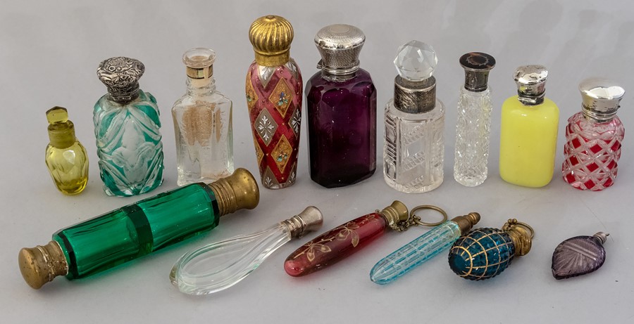A collection of mainly 19th Century glass scent bottles, cut and moulded glass, some coloured and