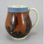 An early nineteenth century mocha ware jug, c.1820. It is decorated with brown and with a blue