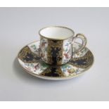 An English Porcelain Cup and Saucer Decorated with Exotic birds and cobalt blue panels with gilt