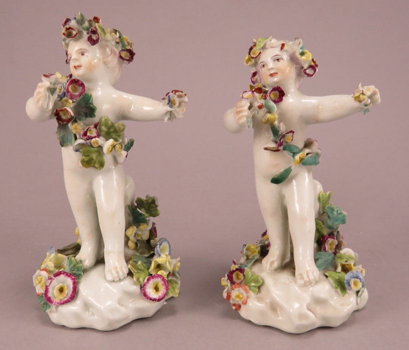 A pair of Derby porcelain cherub figures with encrusted flowers, all hand-painted, c. 1770.