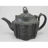 An early nineteenth century black basalt teapot and cover, c.1810. It has a hinged lid with swan