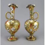 A pair of 19th Century Coalport ewers, flared openings, ring handles, jewelled borders containing