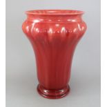 An early twentieth century Royal Lancastrian ox-blood red shaped vase with splayed neck, c.1910-