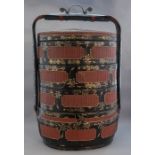 An oriental black lacquer four section lidded stor