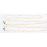 A single string of cultured pearls, creamy white,