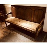 A George III oak settle, circa 1770, moulded top o