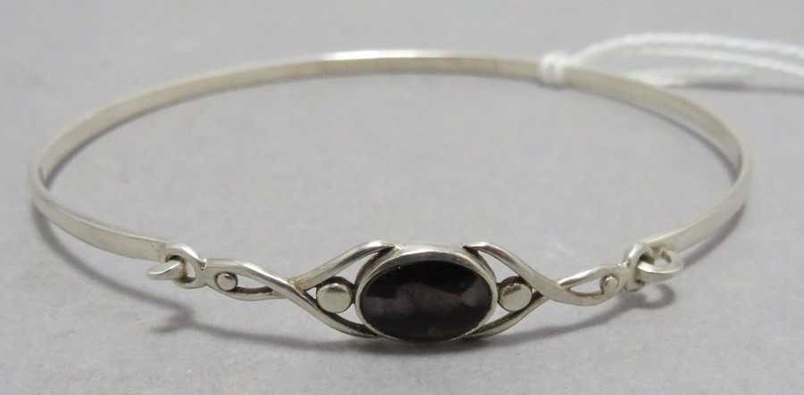 A contemporary silver bangle with Blue John in the