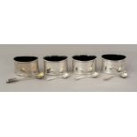 A set of four George V oval silver condiments, pla
