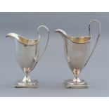 Two Georgian silver helmet shaped jugs, London 179