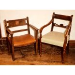 An Arts and Crafts empire style oak armchair, heraldry engraving to the back united with swept arms,