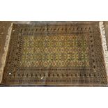 A traditional oriental silk rug, green and rust hu