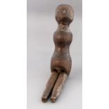 An 18th Century carved wooden doll, inset glass ey