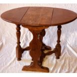 A small 19th Century oak low dropleaf table, in a