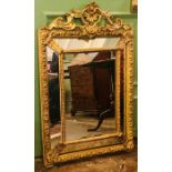 An 18th Century gilt mirror, rococo design, scroll