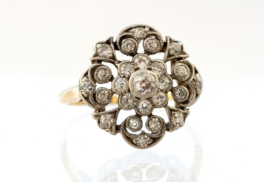 An Edwardian diamond cluster Ring, rub-over set ce