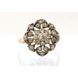 An Edwardian diamond cluster Ring, rub-over set ce