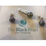 An 18K black pearl and diamond Pendant, having rec