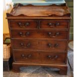 A George III mahogany bedside commode, circa 1800, in form of a chest of drawers, full carved