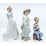 Three Nao figures, two young ladies and a boy with a dog