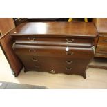 A contemporary mahogany effect bedroom suite, comprising bombe chest of drawers, a pair of bedside