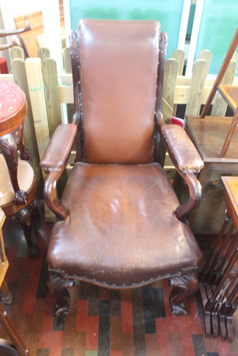 ***LOCATED AT GRESLEY****An early Victorian rosewood armchair with leather seat back and arms, on