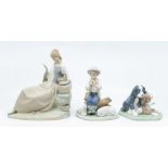 Three Nao figures, boy playing flute, pair of dogs, a lady reading a note